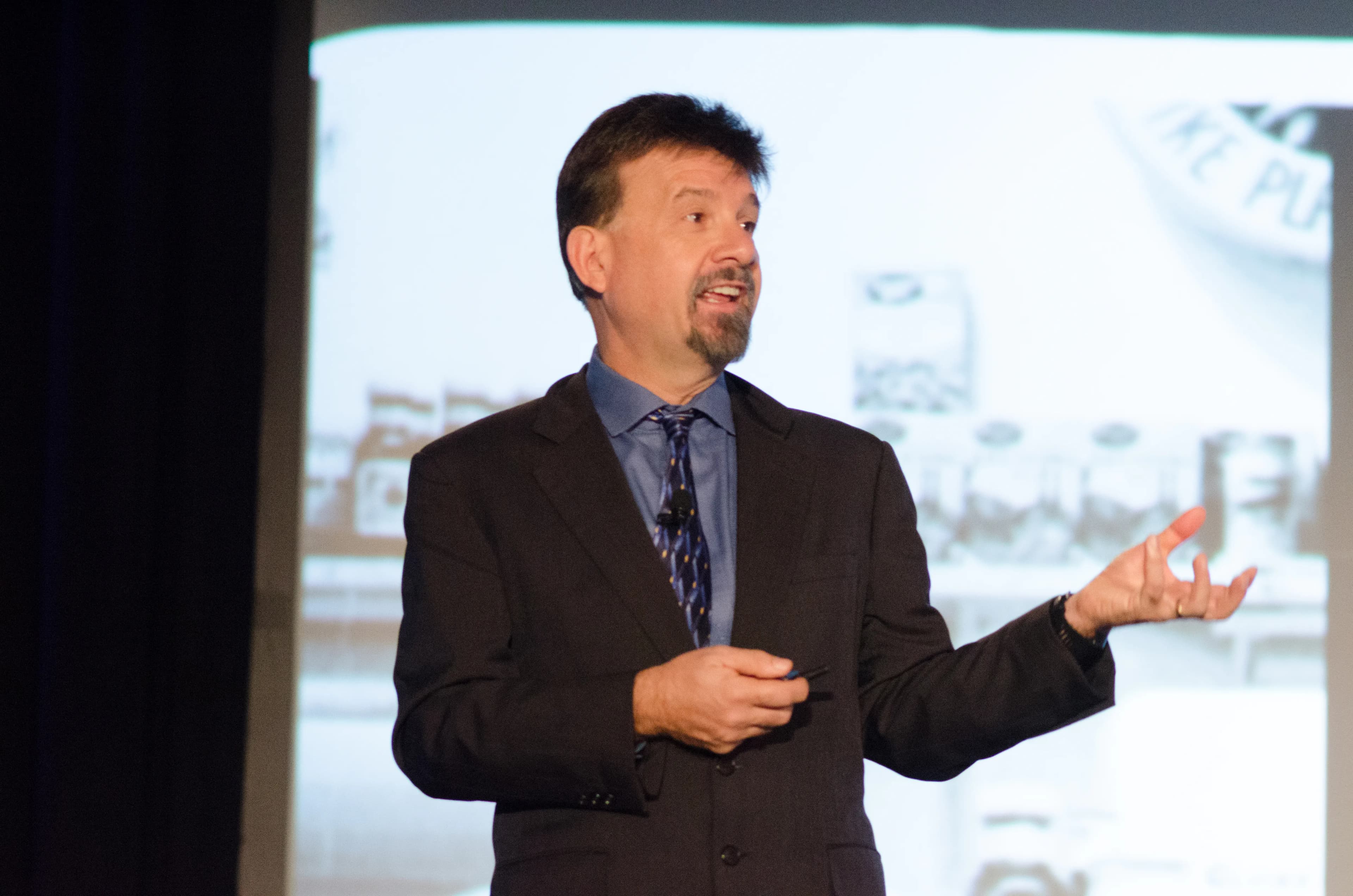 Joseph Michelli on stage at a customer experience event