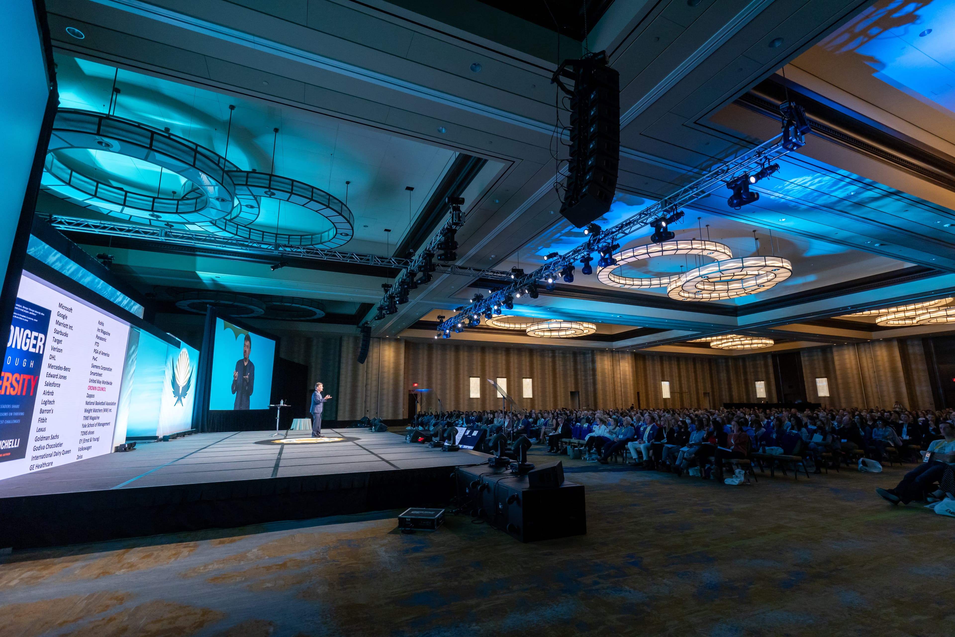 Joseph Michelli on stage to a packed ballroom