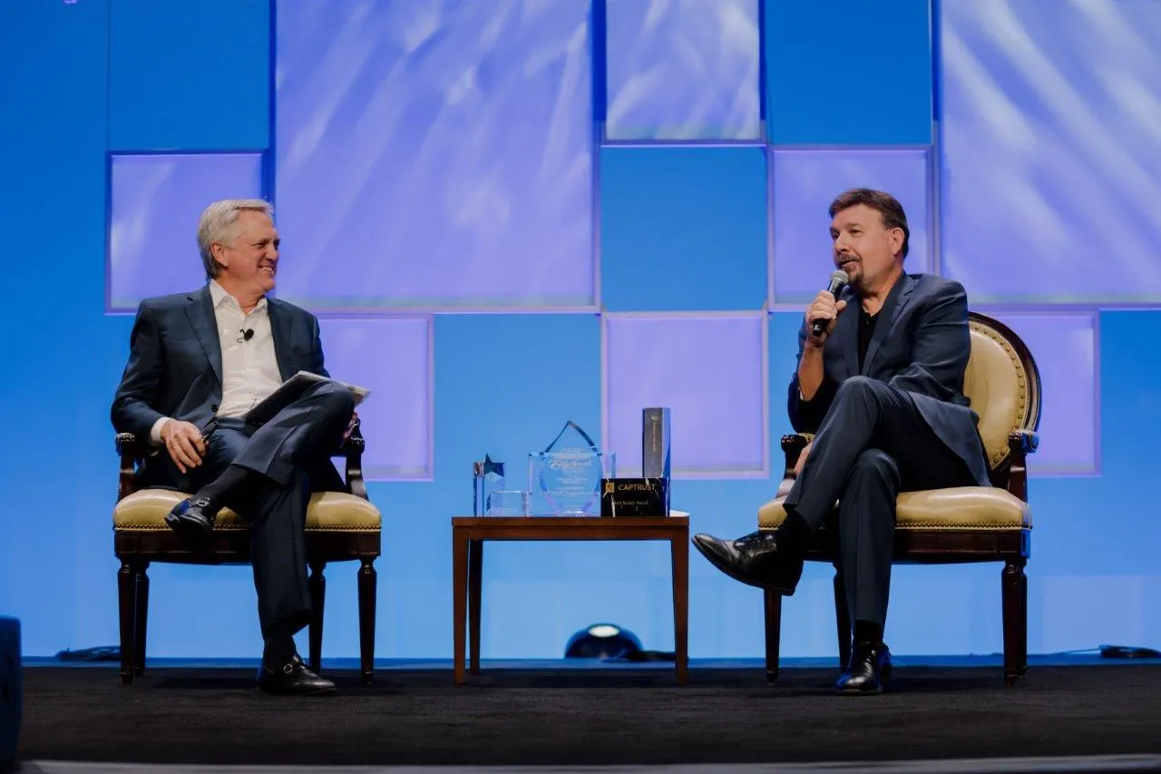 Joseph Michelli moderating a fireside chat with leaders