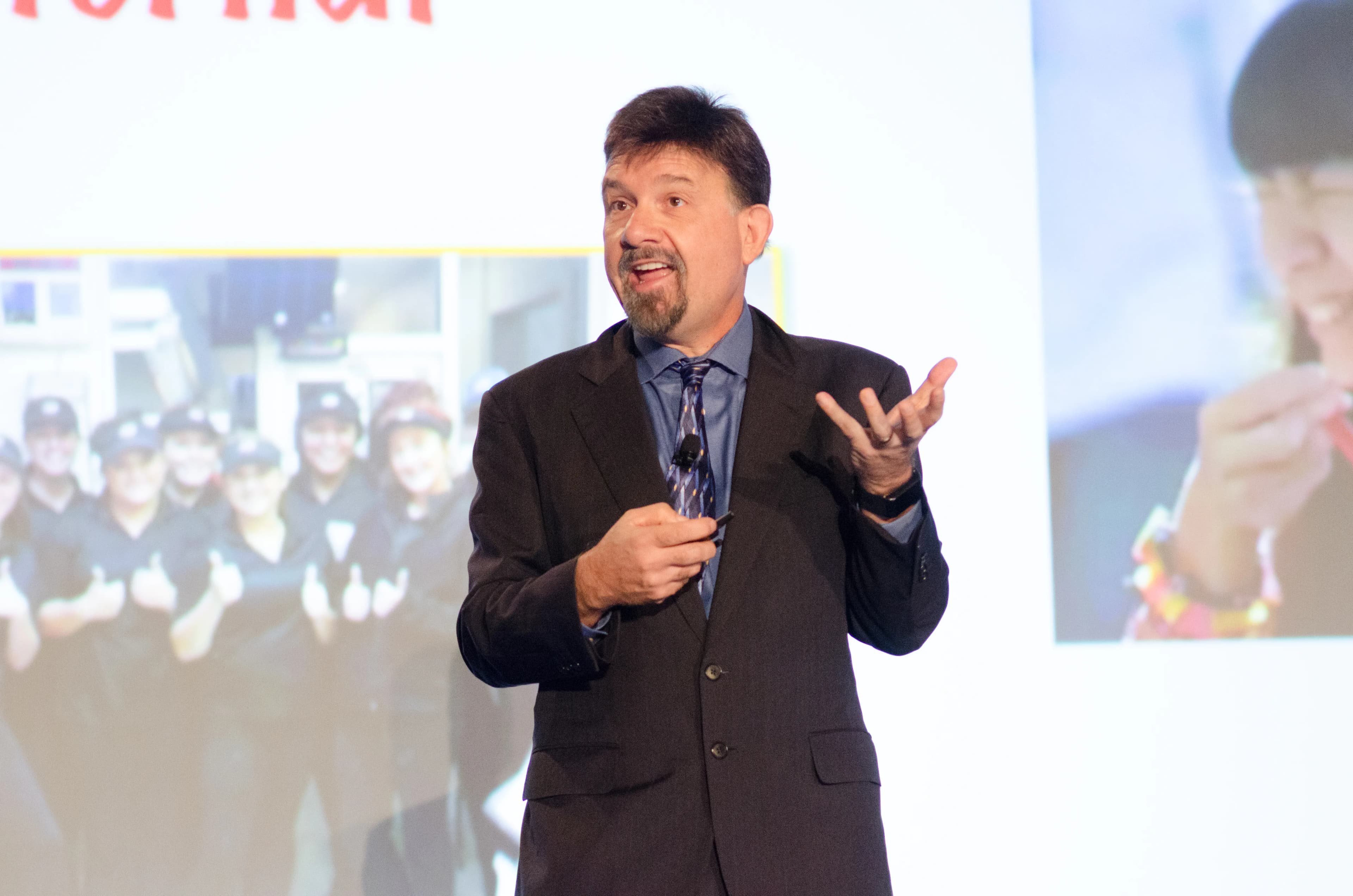 Joseph Michelli delivering a keynote on stage